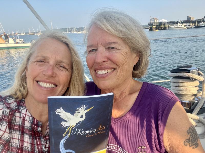 Patrisha McLean, CEO and founder of Finding Our Voices, with Adventurer Heidi Love, who will join the online discussion of her new book Laughing at the Sky in June's edition of the Finding Our Voices Bookclub. The book in the photo is a healing workbook penned by Heidi Love that the group distributes as a peer-support gift to Maine women survivors of domestic abuse. (Photo courtesy Finding Our Voices)