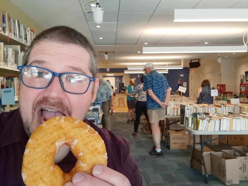 Rockport Library Director Ben Blackmon enjoys sweet treats and sweet deals at the 2023 Donut Festival Book Sale. (Photo courtesy Rockport Public Library)