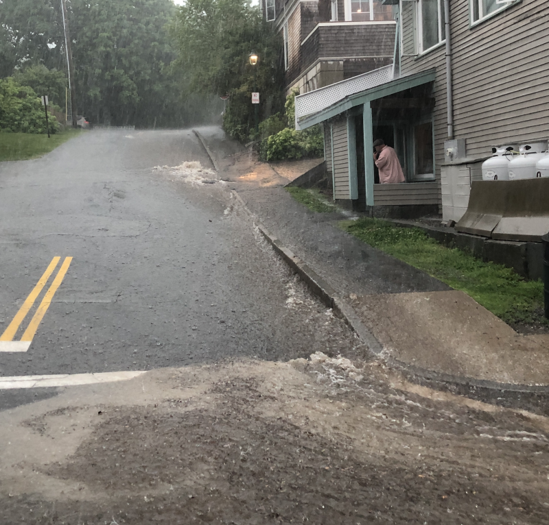 Water gushes down Frye Street to Bay View Street, in Camden.