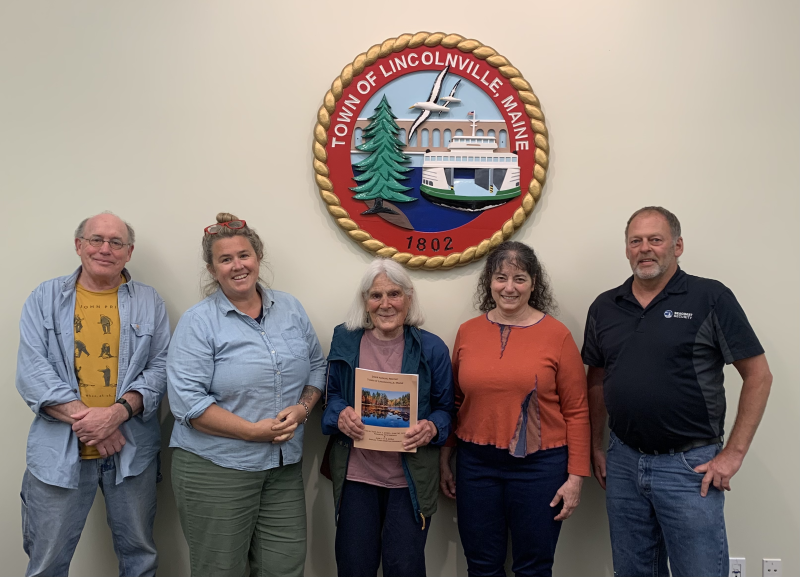 Lincolnville Select Board members Mike Ray, Ladleah Dunn, with Corelyn Senn in the middle, and board members Robyn Tarantino and Keryn Laite, June 6, at the dedication of the 2024 Town Report to Senn. (Photo by Lynda Clancy)