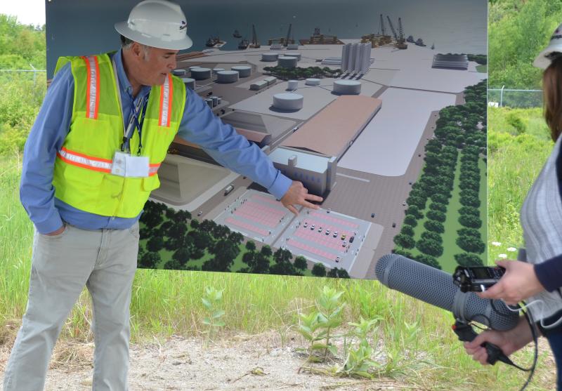 Sprague’s Vice President of Materials Handling James Therriault illustrates the Mack Point plan with a rendering of the site. The perspective is from a small hill on the inland portion of Sprague’s Searsport land. (Photo by Lynda Clancy)