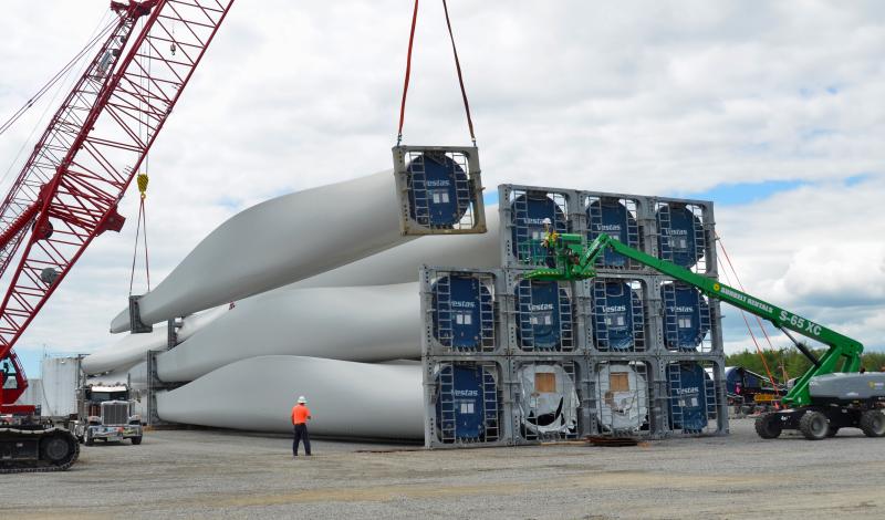 Wind turbine blades have been unloaded at Mack Point from a ship that sailed in from India, and are being stacked in place prior to truck transport to northern and eastern Maine land-based wind power facilities. (Photo by Lynda Clancy)