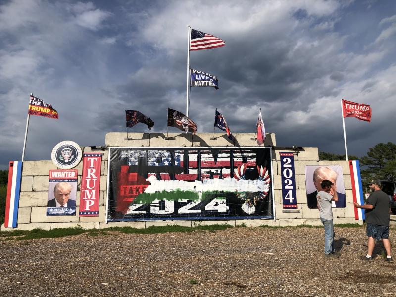 In Waldoboro, Anthony Lash (left) talks with neighbors about the recent vandalization of the large monument to President Trump. Sometime during the final week of May, the banner stating TRUMP 2024 was painted with an image which appears to be similar to the Palestinian Flag. (Sarah Masters photo)