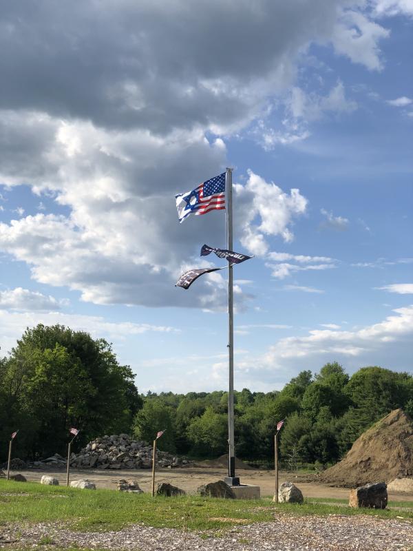Anthony Lash believes the monument, which sits on his father Tony Lash’s property, was vandalized after his father installed this flag during Memorial Day weekend. The flag combines images of the American and Israeli state flags. (Sarah Masters photo)