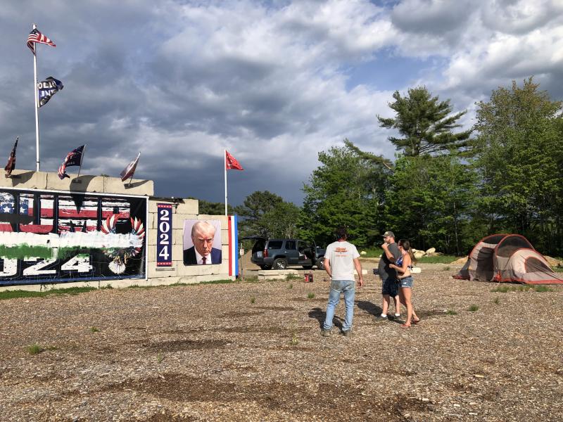 Anthony Lash talks with neighbors about the increased security the family has established at the site of the vandalized monument to former President Trump, in Waldoboro on May 31. (Sarah Masters photo)