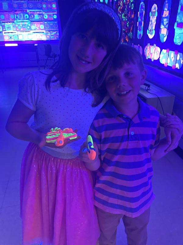 Norah & Andrew Smith with their “glow bugs”. (Photo courtesy Thomaston Grammar School)