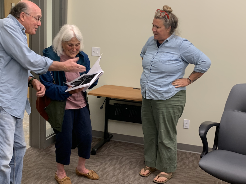 Select Board members Mike Ray and Ladleah Dunn show the dedication pages to Corelyn Senn. (Photo by Lynda Clancy)