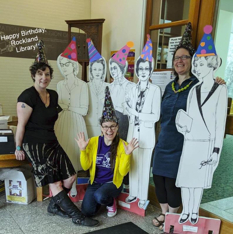 Jessie, Patty, and children’s librarian Katie Drago with cutouts of some of the former head librarians on the 115th birthday of the library in 2019. (Photo courtesy Rockland Public Library)