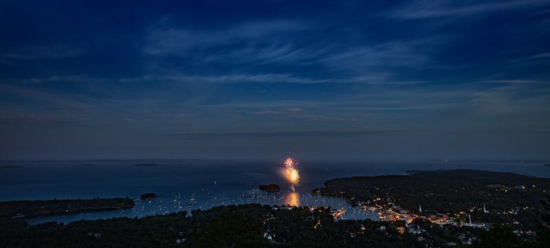 A panoramic shot of Camden Harbor, and in the distance: Owl’s Head Light, Heron Neck Light (dead center, in extreme background, on Green’s Island, off Vinalhaven) and the three turbines on Vinalhaven. (Photo courtesy Peter Ralston)