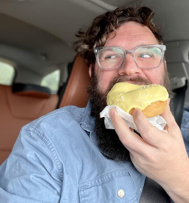 Adam Mills with the “Into the Light!” Offering from The Only Doughnut in a selfie that makes him eligible for the event’s raffle.