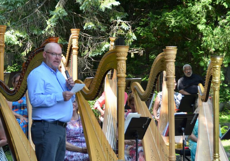 John Carrington, Principal Harpist with the Pacific Northwest Ballet Orchestra and the Auburn Symphony, presented a brief and poignant history of the Salzedo Harp Colony to the audience at the July 14 concert in Camden. (Photo by Lynda Clancy)
