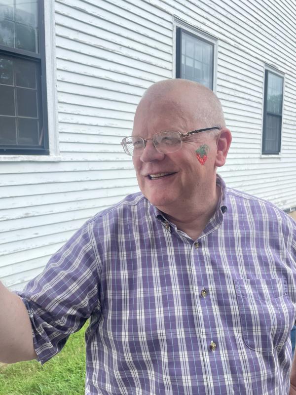 David Kinney poses with his strawberry painted face. (Photo by Ed O’Brien)