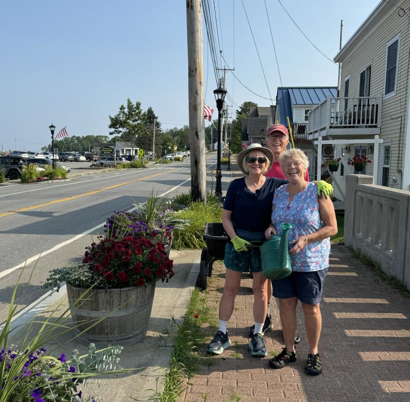 Dennis and Connie Linhart and Dorothee Newcombe tend to the flowers at the Beach. (Photo by Ed O’Brien)