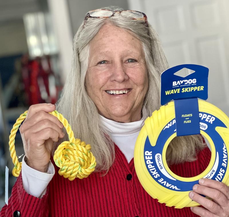 Eliza Massey with dog toys from The Maine Dog for the “Into the Light!” pet gift basket that can be won with an uploaded selfie in the event’s raffle. Loyal Biscuit contributed $100 worth of yellow cat and dog toys and snacks to the pet gift basket. (Photo by Patrisha McLean)