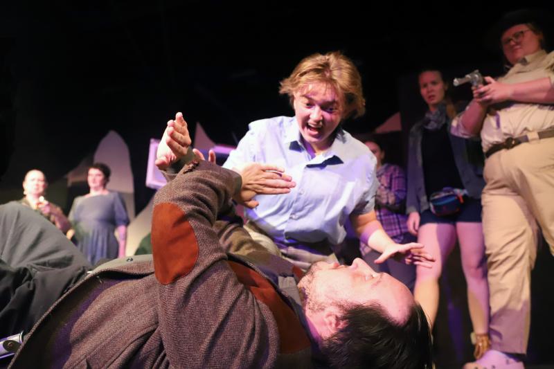 Bat Boy (Miles Mailloux) attacks Dr. Parker (Andrew Lipman) as the
citizens of Hope Falls look on. (l-r in background: Christine Goosman, Angelina Nichols, Ada Curry, Gwen Sauvage). (Photo courtesy Belfast Maskers)