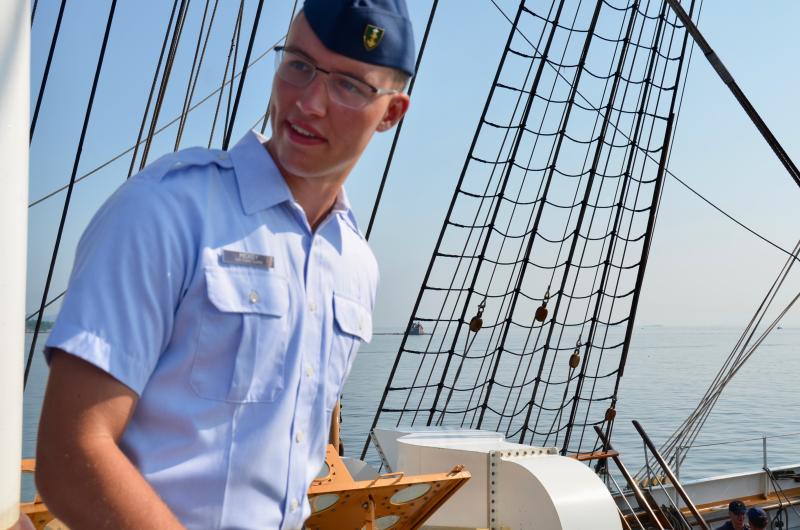 Lieutenant Junior Grade Zachary Beaudoin, of Scarborough, Maine, has been on the Eagle since 2022 as a deck watch officer. He and the several other watch officers are responsible for the safe operation of the ship, and a direct representative of Captain Jessica Rozzi-Ochs when she is not present. He came into the Coast Guard from officer candidate school, and prior to that, he was with the U.S. Marine Corps. “I really love the Coast Guard mission. You are saving lives and helping the homeland.” His wife is also from Scarborough, and in the Coast Guard herself, stationed at the Academy. They have two sons. “I am planning to make a career of this. I love the Coast Guard and looking forward to serving more.” Preferably in New England, and maybe Maine, they hope. (Photo by Lynda Clancy)