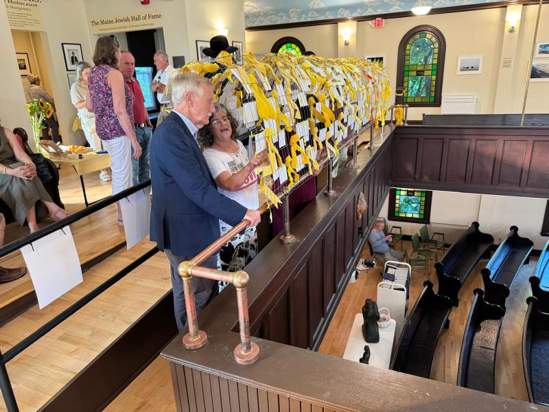 Maine Senator Angus King tours the exhibit with Camille Davidson. (Photo courtesy Jordan Cohen)