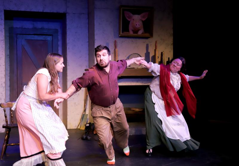 (l-r) Pegeen Mike (Greta Brown) wrestles Christy (Tyler Johnstone) away from The Widow Quin (Emily LeBlanc McConnell) in a scene from "The Playboy of the Western World" by J.M. Synge. (Photo by Gwyneth Sauvage)