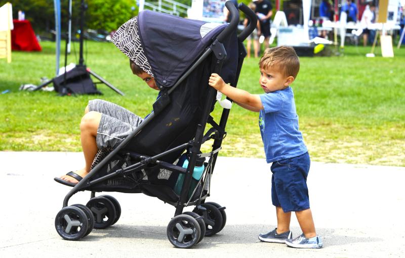This young man pushed a stroller with his big brother as passenger along the Harborwalk at the 17th annual Belfast Harbor Fest, hosted by Belfast Rotary Club, on Aug. 18. This young man pushed a stroller with his big brother as passenger along the Harborwalk at the 17 th annual Belfast Harbor Fest, hosted by Belfast Rotary Club, on Aug. 18.
