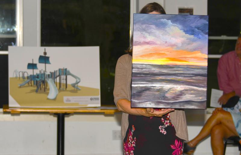 Pictured here at Belfast Rotary Club’s Evening by the Bay gala and auction, the event that launched the 17th annual Belfast Harbor Fest on Aug. 17, are a rendering of the club’s $200,000 centennial playground Legacy Project (left), to be built at City Park in Belfast in 2025, and “Glow,” an original oil painting by Jerri Finch which went to the high bidder at the live auction. Pictured here at Belfast Rotary Club’s Evening by the Bay gala and auction, the event that launched the 17th annual Belfast Harbor Fest on Aug. 17, are a rendering of the club’s $200,000 centennial playground Legacy Project (left), to be built at City Park in Belfast in 2025, and “Glow,” an original oil painting by Jerri Finch which went to the high bidder at the live auction.