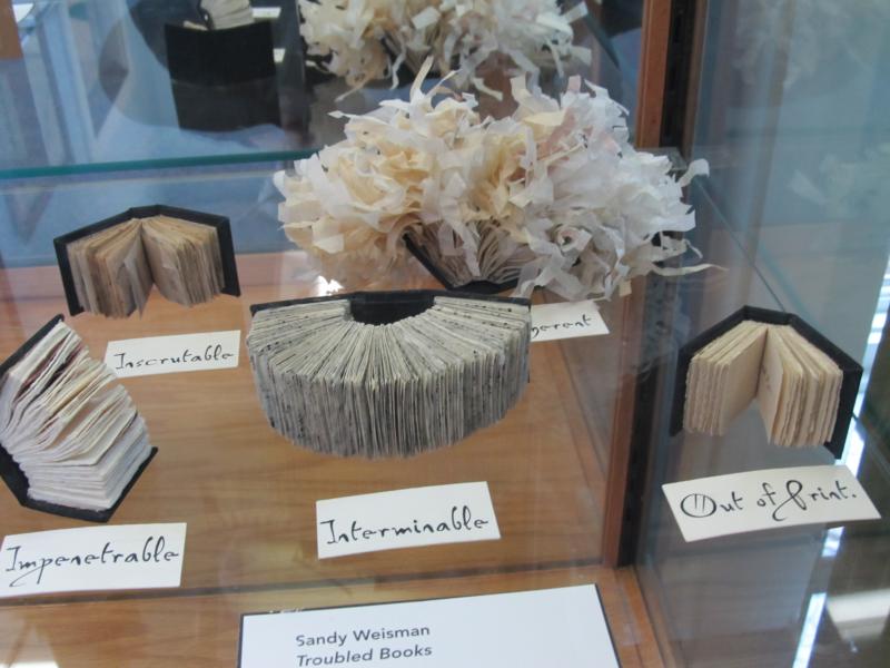 Sandy Weisman, of South Thomaston, one of the book artists involved, created a gallery of tiny books called "Troubled Books." (Photo by Kay Stephens) Sandy Weisman of South Thomaston, one of the book artists involved, created a gallery of tiny books called "Troubled Books."