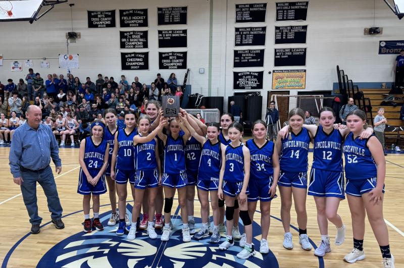 Coach Roman McDonald and the Runner Up Girls Middle School Basketball Team. (Photo by Deb Harbaugh) Basketball