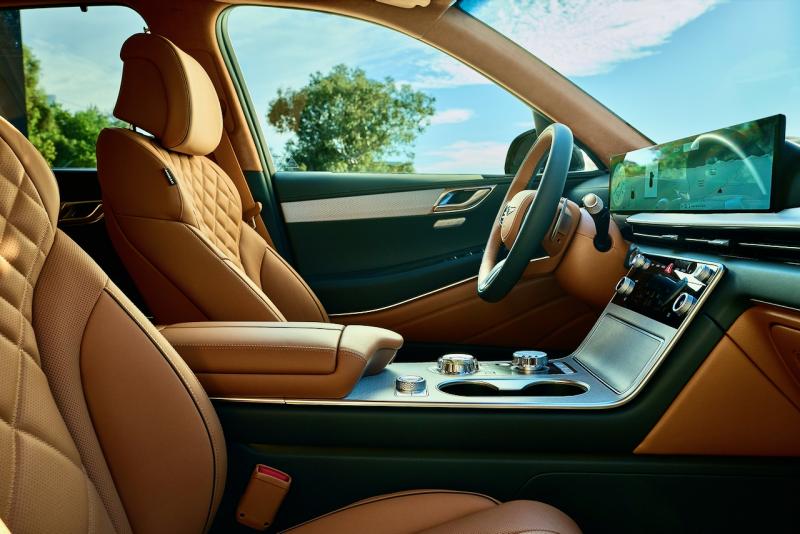 Interior upgrades to the GV80 for 2025 include this new sweeping 27-inch touchscreen that houses both the driver’s gauge cluster and the shared infotainment display, as well as three new interior colors: Earth Brown (shown), Bordeaux Brown and Glacier white. Serenity, and comfort and high-touch materials come standard with every Genesis. Interior upgrades to the GV80 for 2025 include this new sweeping 27-inch touchscreen that houses both the driver’s gauge cluster and the shared infotainment display, as well as three new interior colors: Earth Brown (shown), Bordeaux Brown and Glacier white. Serenity, and comfort and high-touch materials come standard with every Genesis.