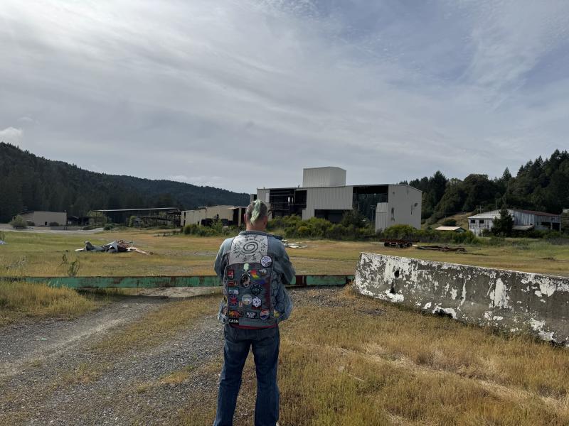 Justin surveys what remains of the Harwood mill, site of a high school summer job. (Photo by Ed O’Brien) Mill