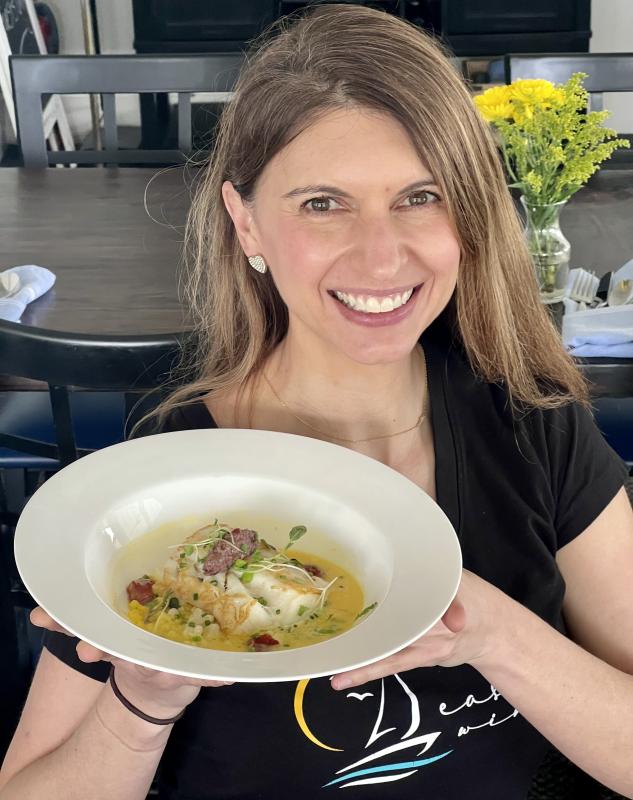 Danielle Turner with the "Into the Light!" roasted cod with pearled couscous, tomato jam, olive tapanade, and safffron nage at the Harborview Bistro at the East Wind Inn. (Photo by Patrisha McLean) Danielle Turner with the "Into the Light!" roasted cod with pearled couscous, tomato jam, olive tapanade, and safffron nage at the Harborview Bistro at the East Wind Inn. (Photo by Patrisha McLean)