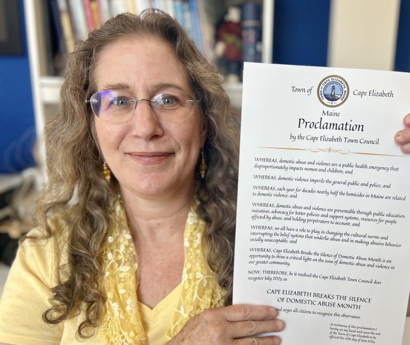 Rachel Davis, director of the Thomas Memorial Public Library, with the town of Cape Elizabeth proclamation declaring that "Domestic abuse is a public health emergency disproportionately impacting women and children" and deeming the Finding Our Voices and library July collaboration "an opportunity to shine a critical light on the domestic abuse in our greater community." (Photo by Patrisha McLean) Rachel Davis, director of the Thomas Memorial Public Library, with the town of Cape Elizabeth proclamation declaring that "Domestic abuse is a public health emergency disproportionately impacting women and children" and deeming the Finding Our Voices and library July collaboration "an opportunity to shine a critical light on the domestic abuse in our greater community." (Photo by Patrisha McLean)
