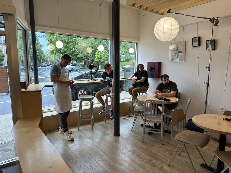 Cast and crew members of 'Rivers Edge' take a brief break while filming in Zoot Coffee in Camden. (Courtesy photo) 4 people in a coffee shop, 3 sitting and 1 wearing an apron, look off camera