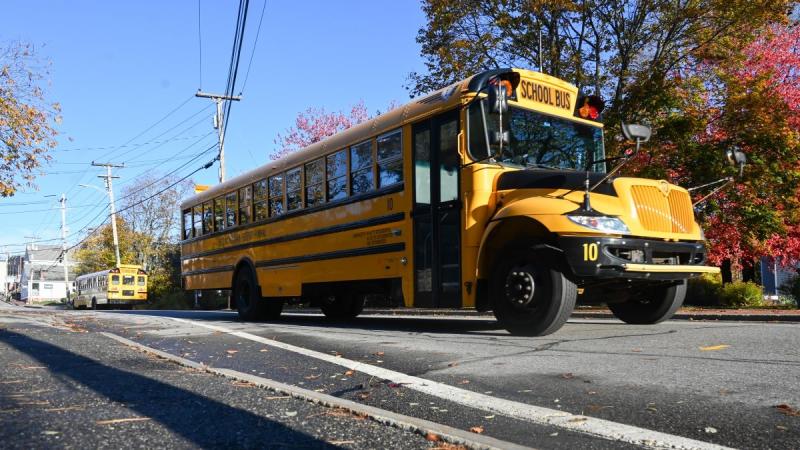 Maine has seen test scores drop on a national test for more than a decade. Data show that some of Maine’s most vulnerable students are falling the furthest. Photo by Kristian Moravec. school bus driving down a street.