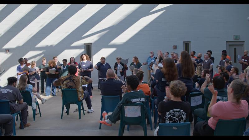 Concert for staff and fellow incarcerated individuals at the Chesterfield County Jail in Richmond, Virginia performing songs written during songwriting workshops. Performers include all workshop participants, 15 singers from the outside community and Unlocking Harmony staff. (Photo courtesy Strand Theatre) Concert for staff and fellow incarcerated individuals at the Chesterfield County Jail in Richmond, Virginia performing songs written during songwriting workshops. Performers include all workshop participants, 15 singers from the outside community and Unlocking Harmony staff. (Photo courtesy Strand Theatre)