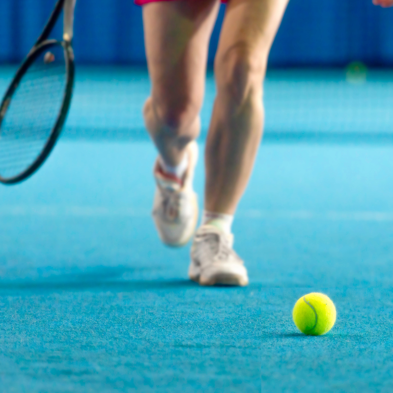 Cardio Tennis Female tennis player walking towards tennis ball