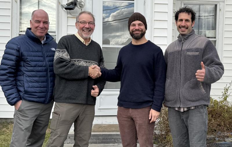 Steve Matteo, Jonathan M. Goss, Adam Pereira and Aaron Englander, at the real estate closing. (Photo Maine Coast Heritage Trust)