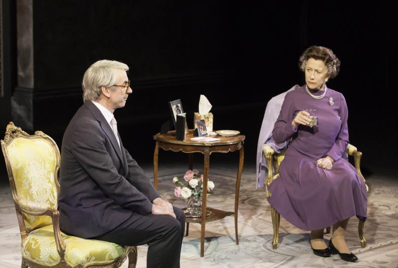 man and woman sit in conference