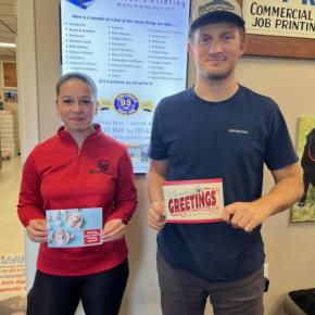 Female and male hold greeting cards