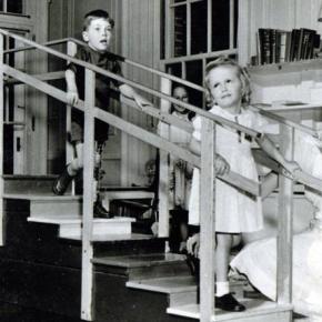 Children on stairs with nurse