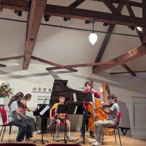 five teenagers play instruments