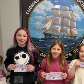 six kids in front of school logo