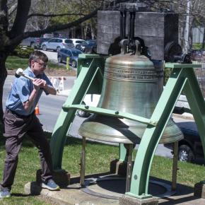 Peter Crockett rings a giant memorial bell
