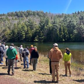 workshop participants at a pond
