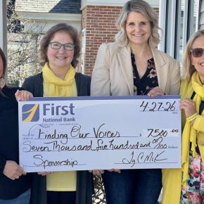 four women hold presentation check