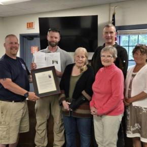 presenting framed copy of dedication