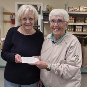 Goose River Golf Club Ladies League Manager Faith Vautour (R) presents a $1,000 check to Penny Baum, vice president of the Camden Area Christian Food Pantry Board of Directors.
