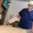 In his workshop, Adrian Turner shows the wire mesh interior of one of his bat houses.