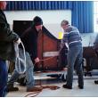 BELFAST - A piano donated by Bruce Starret arrives at Belfast Area High School. Music teacher John Cameron, striped shirt, said new instrument will allow for piano duet recitals without moving a third piano off the auditorium stage each time. (Photo by Ethan Andrews)
