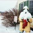 BELFAST - Behind a snow covered fisherman outside Perry's Nut House, the fisherman sign for the Jed's Restaurant is visible, at left. Both local landmark properties are currently for sale. (Photo by Ethan Andrews)