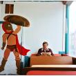BELFAST - A partially-completed mural of a Spartan warrior at Alexia's Pizza painted by Maleah Chadwick of Searsmont . Owner Ted Rakis, who was born within a mile of the tomb of King Leonidas in Sparta, sits in his customary seat at the restaurant. (Photo by Ethan Andrews)