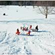 NORTHPORT - Sledders at the Northport Golf Club disperse after converging on a boy who had the wind knocked out of him after going over a small jump. (Photo by Ethan Andrews)